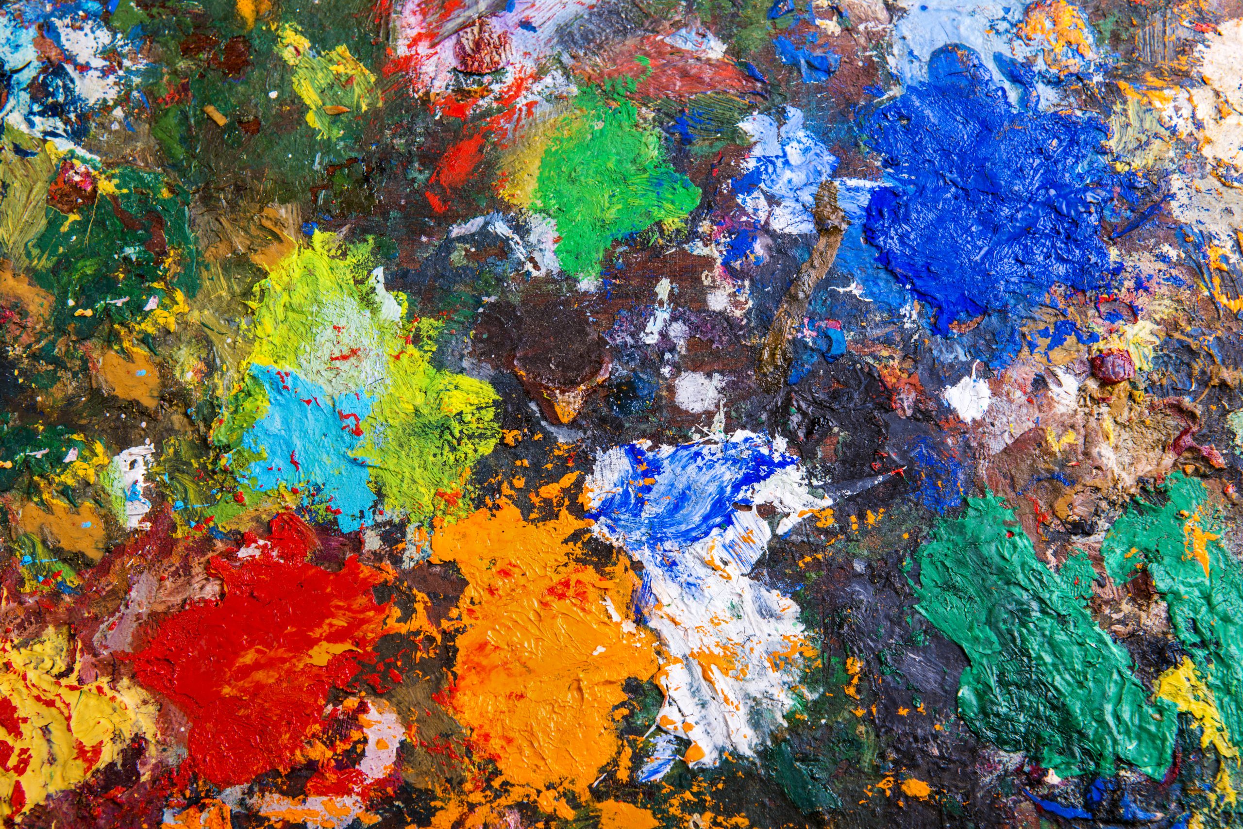 Palette with paints Art palette background with various acrylic paint spots