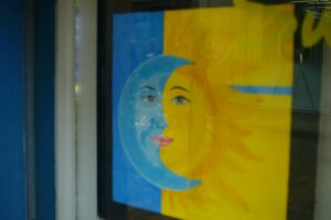 Artistic depiction of sun and moon faces